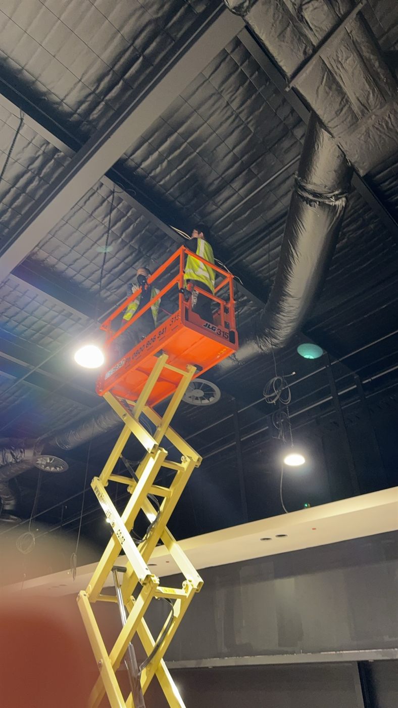 High access CCTV cabling and camera installation work inside a retail fit-out