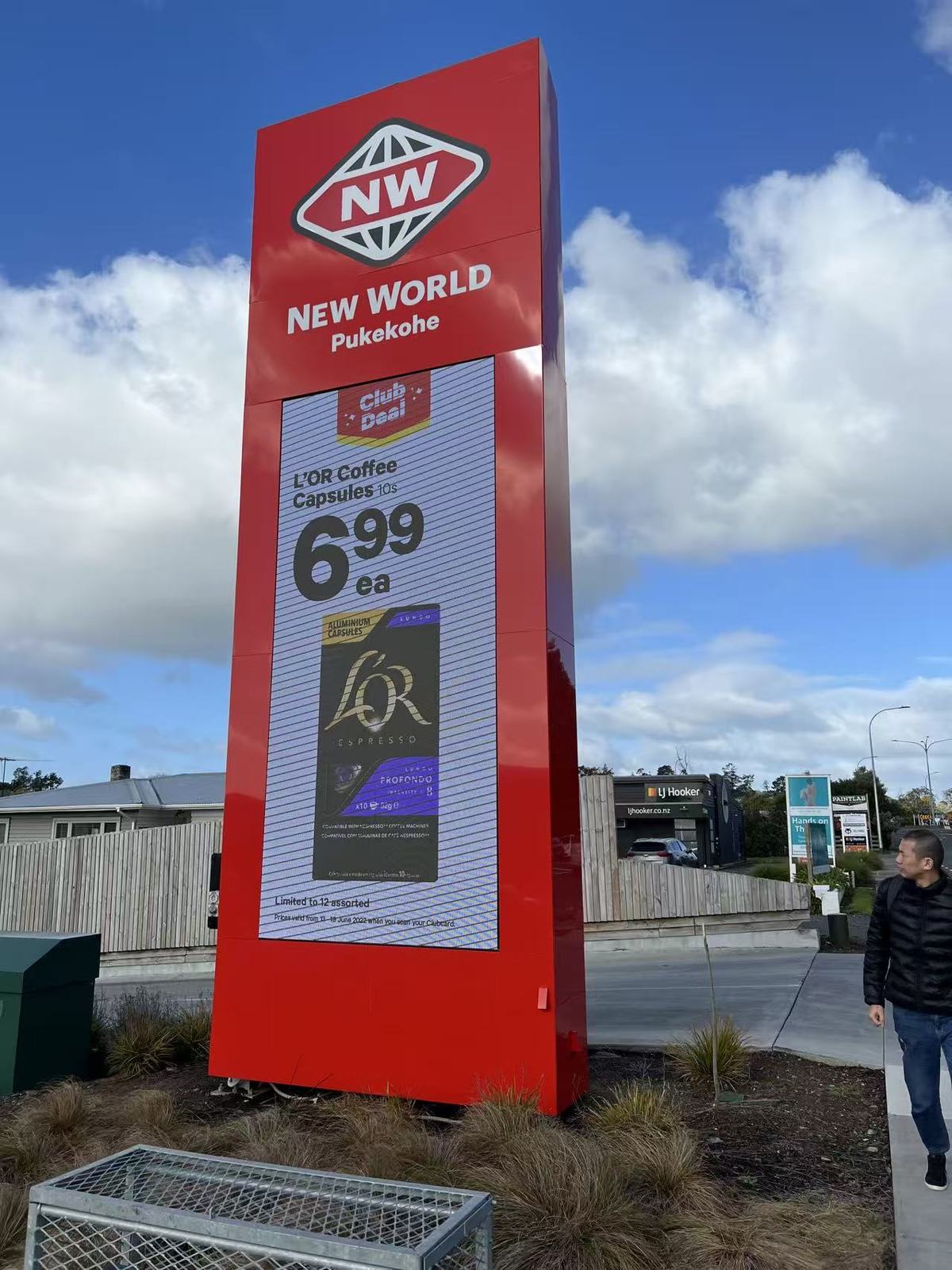 New World outdoor LED display pylon showing supermarket promotion