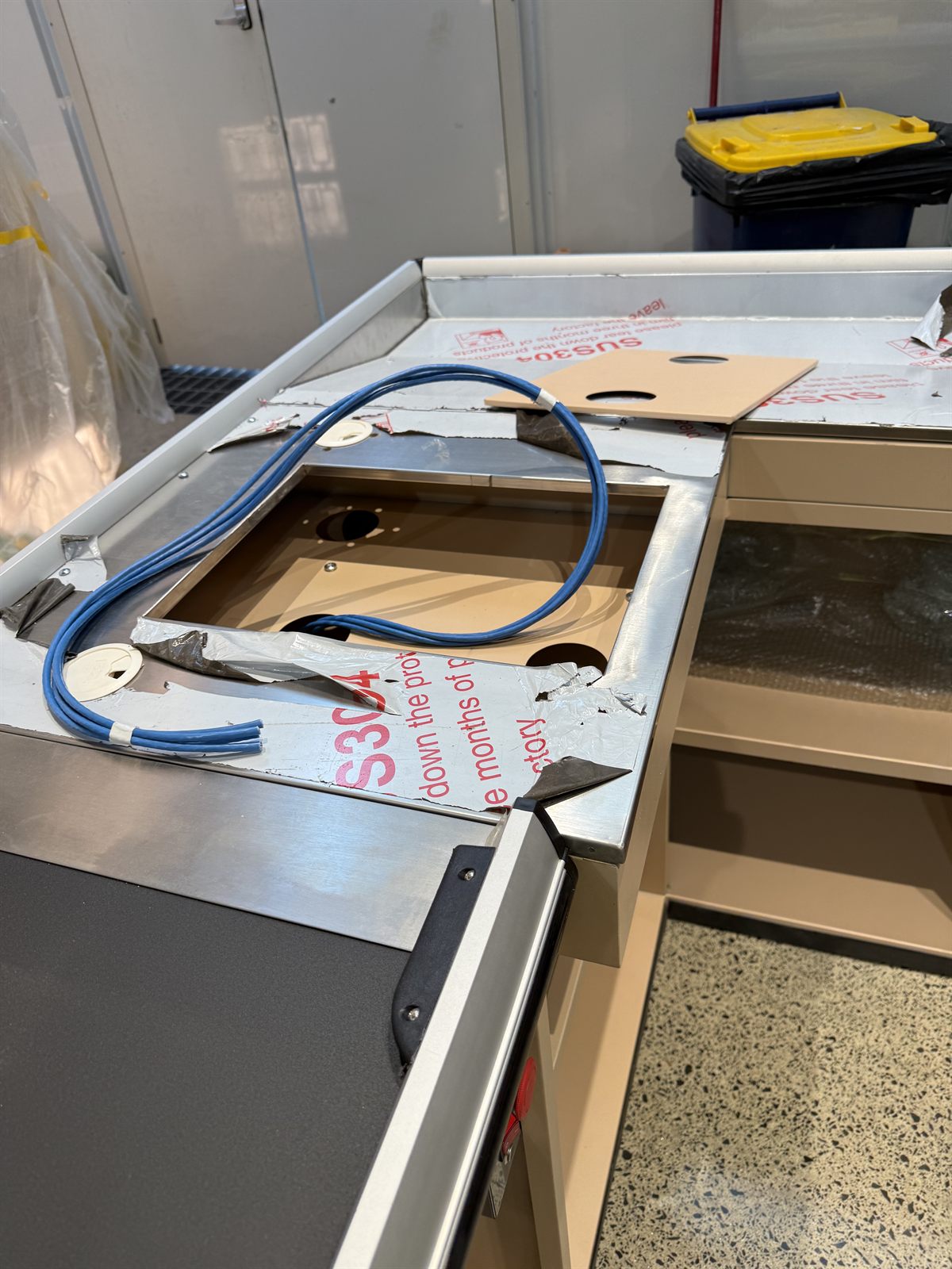 Network cabling routed through a checkout counter for POS systems