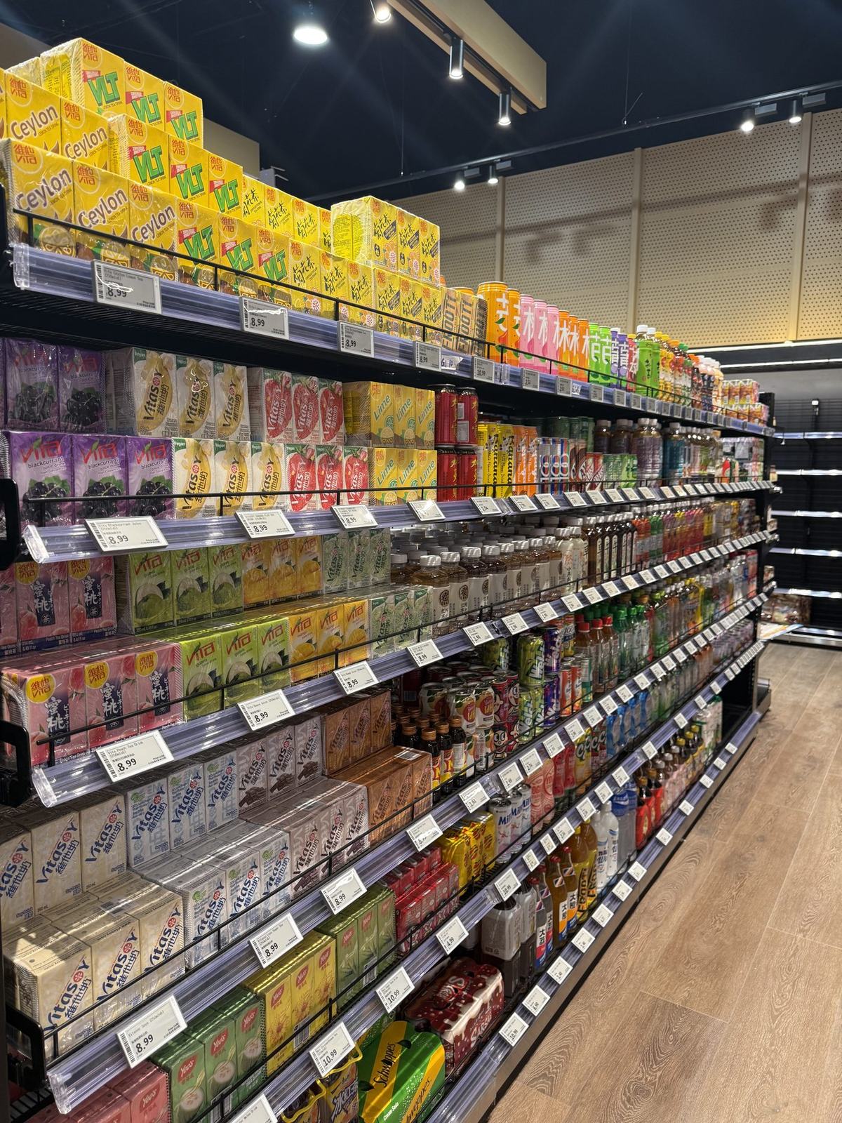 Electronic shelf labels installed across a supermarket drinks aisle